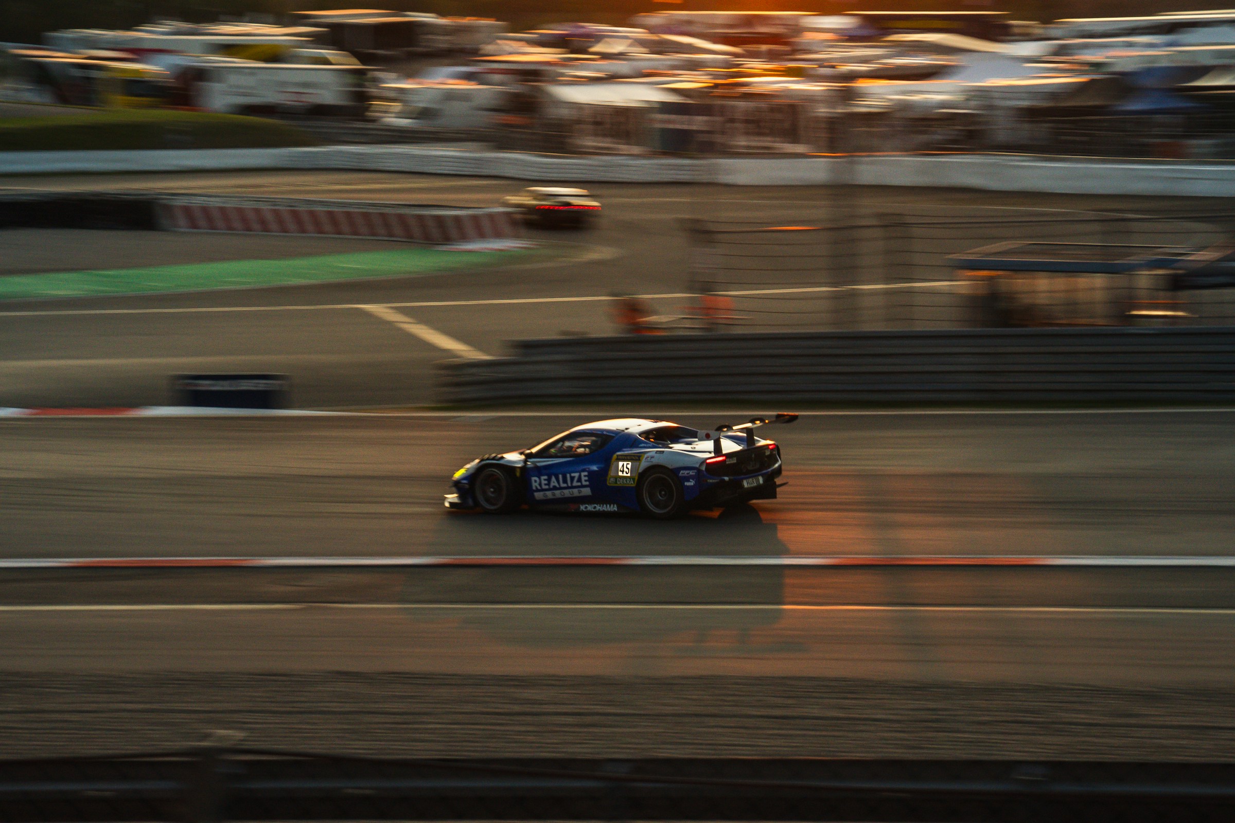 A GT race car on track in the warm evening light